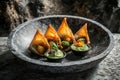 A plate of crispy samosas served with green chutney in a stylish bowl Royalty Free Stock Photo