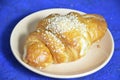 A plate with croissant cup of black with milk coffee and. Top View. The croissant is decorated with sesame. Complement the Royalty Free Stock Photo