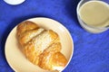 A plate with croissant cup of black with milk coffee and. Top View. The croissant is decorated with sesame. Complement the Royalty Free Stock Photo