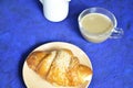 A plate with croissant cup of black with milk coffee and. Top View. The croissant is decorated with sesame. Complement the Royalty Free Stock Photo