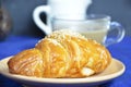 A plate with croissant cup of black with milk coffee and. Top View. The croissant is decorated with sesame. Complement the Royalty Free Stock Photo