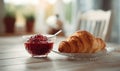 A plate of croissants sits on a table next to a glass bowl of jam Royalty Free Stock Photo