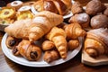 plate of croissants, with variety of pastries and confections for the eyes and tastebuds