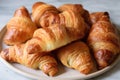 plate of croissants, warm and flaky on the inside and golden brown on the outside