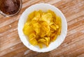 Potato chips served with glass of beer Royalty Free Stock Photo