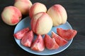 Plate of Cut Fresh Ripe Peaches for Dessert with Whole Fruits in Background Royalty Free Stock Photo