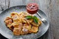 Plate with cutted pancakes and plum jam