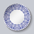 Plate decorated with blue floral patterns in the style of the national porcelain painting with empty space in the center isolated Royalty Free Stock Photo