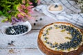 Plate with decorated blueberry cheesecake on wooden white table Royalty Free Stock Photo