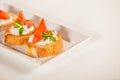 Plate of decorative salmon fish on bruschetta appetizer Royalty Free Stock Photo