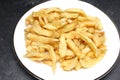 A plate of deep fried potato chips from an English Fish and Chips shop