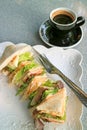 Plate of Delectable Sandwiches Served with a Cup of Hot Coffee on a Marble Table