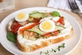 Plate of delicious bruschettas with salmon on wooden table Royalty Free Stock Photo