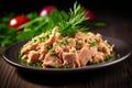 A close-up of a plate featuring delicious canned tuna adorned with fresh herbs