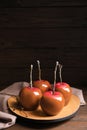 Plate with delicious caramel apples on table Royalty Free Stock Photo