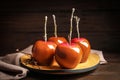 Plate with delicious caramel apples on table Royalty Free Stock Photo