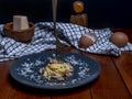 A plate of carbonara-style rolled spaghetti, with a fork skewered on top Royalty Free Stock Photo