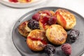 Plate of delicious cottage cheese pancakes with raspberry and blackberry, closeup Royalty Free Stock Photo