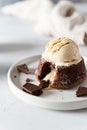 Plate of delicious french fondant with hot chocolate and vanilla ice cream scoop ont the top on the plate. Lava cake recipe, menu Royalty Free Stock Photo