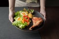 plate of delicious grilled chicken legs steak with vegetable salad Royalty Free Stock Photo