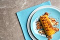 Plate with delicious grilled corn cob and spices on table Royalty Free Stock Photo