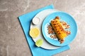 Plate with delicious grilled corn cob and spices on table Royalty Free Stock Photo