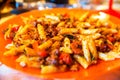 Plate of delicious Italian macaroni with tomato, fresh basil leaves and parmesan Royalty Free Stock Photo