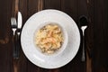 A plate of delicious Italian pasta with shrimp alfredo, mussels and cream sauce over pasta, top view. on wooden Royalty Free Stock Photo