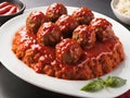 plate with delicious meatballs, tomato sauce and vegetables on table, closeup