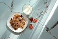 Plate with delicious oatmeal cookies, glass of milk and fresh strawberry on table Royalty Free Stock Photo