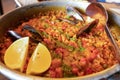 A plate of delicious Paella with yellow lemon & mussel
