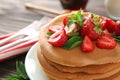 Plate with delicious pancakes and strawberries on table, closeup Royalty Free Stock Photo