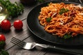 Plate with delicious pasta bolognese on dark wooden table Royalty Free Stock Photo