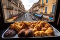 plate of delicious pastries, with view of busy city street visible through the window