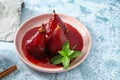 Plate with delicious poached pears in red wine on color table Royalty Free Stock Photo