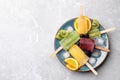 Plate of delicious popsicles, ice cubes and fresh fruits on light grey marble table, top view. Space for text Royalty Free Stock Photo