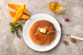 Plate with delicious pumpkin pancakes on table, top view Royalty Free Stock Photo