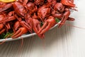 Plate with delicious red boiled crayfish on white wooden table, closeup Royalty Free Stock Photo