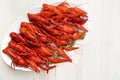 Plate with delicious red boiled crayfish on white wooden table, top view Royalty Free Stock Photo