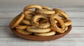 Plate with delicious ring shaped Sushki dry bagels on white wooden table, closeup Royalty Free Stock Photo