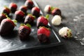 Plate with delicious strawberry covered with chocolate on grey textured background Royalty Free Stock Photo