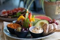 Plate of delicious traditional Ethiopian food and some vegetables on a wooden table