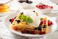 Plate with delicious waffles with berries and ice cream. Close-up Royalty Free Stock Photo