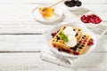 Plate with delicious waffles with berries and ice cream Royalty Free Stock Photo