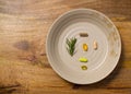 Plate of dietary supplements on aged wooden board Royalty Free Stock Photo