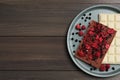 Plate and different chocolate bars with freeze dried fruits on wooden table, top view. Space for text Royalty Free Stock Photo