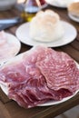 Plate with different cold cuts on a table Royalty Free Stock Photo