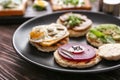 Plate with different delicious toasts on table, closeup Royalty Free Stock Photo