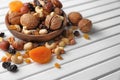 Plate with different nuts and dried fruits on wooden table Royalty Free Stock Photo