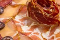Plate of different sliced hams. Spanish raw choron and red chorizo arranged in a flower.